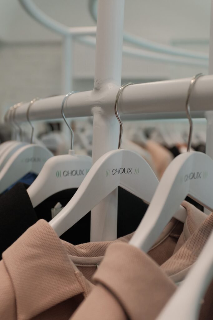 Luxury fashion clothes on wooden hangers -DupeMuse